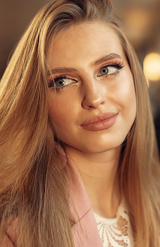 Young woman with long hair and natural makeup.