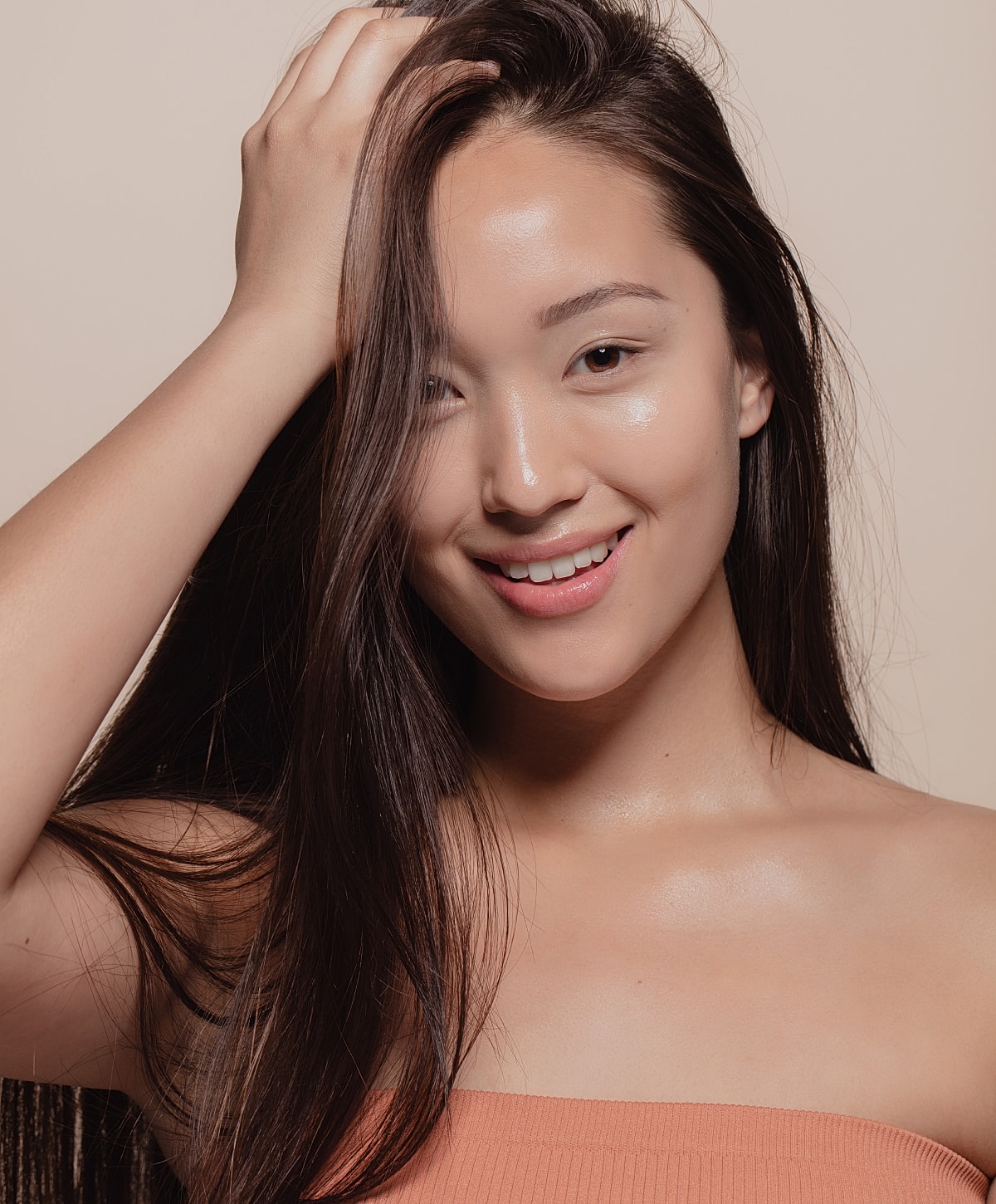 Smiling person with long hair and natural skin.