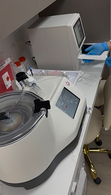 Laboratory equipment with a centrifuge and monitor.