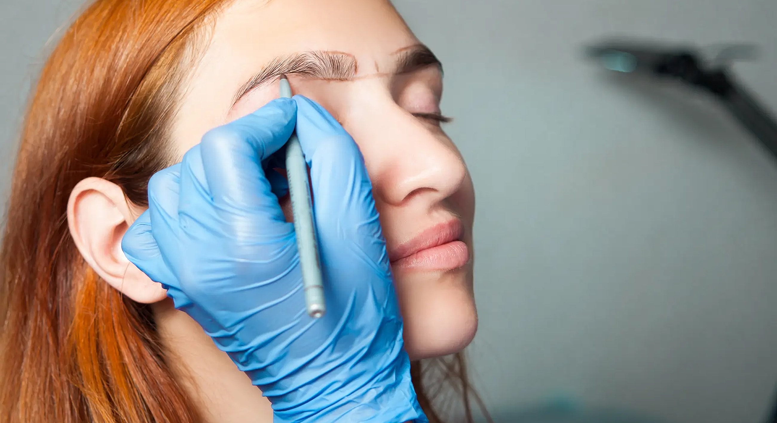 Eyebrow shaping process on a woman’s face.